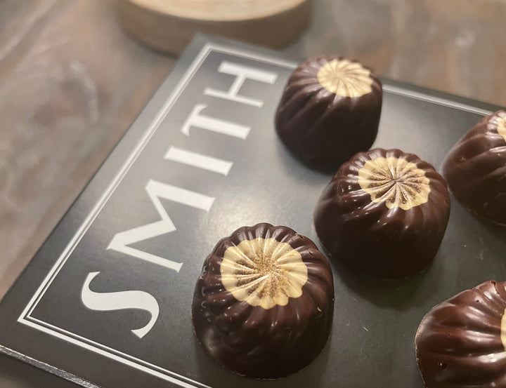Several Chai Tea Bonbons on a Smith Teamaker black tea box.