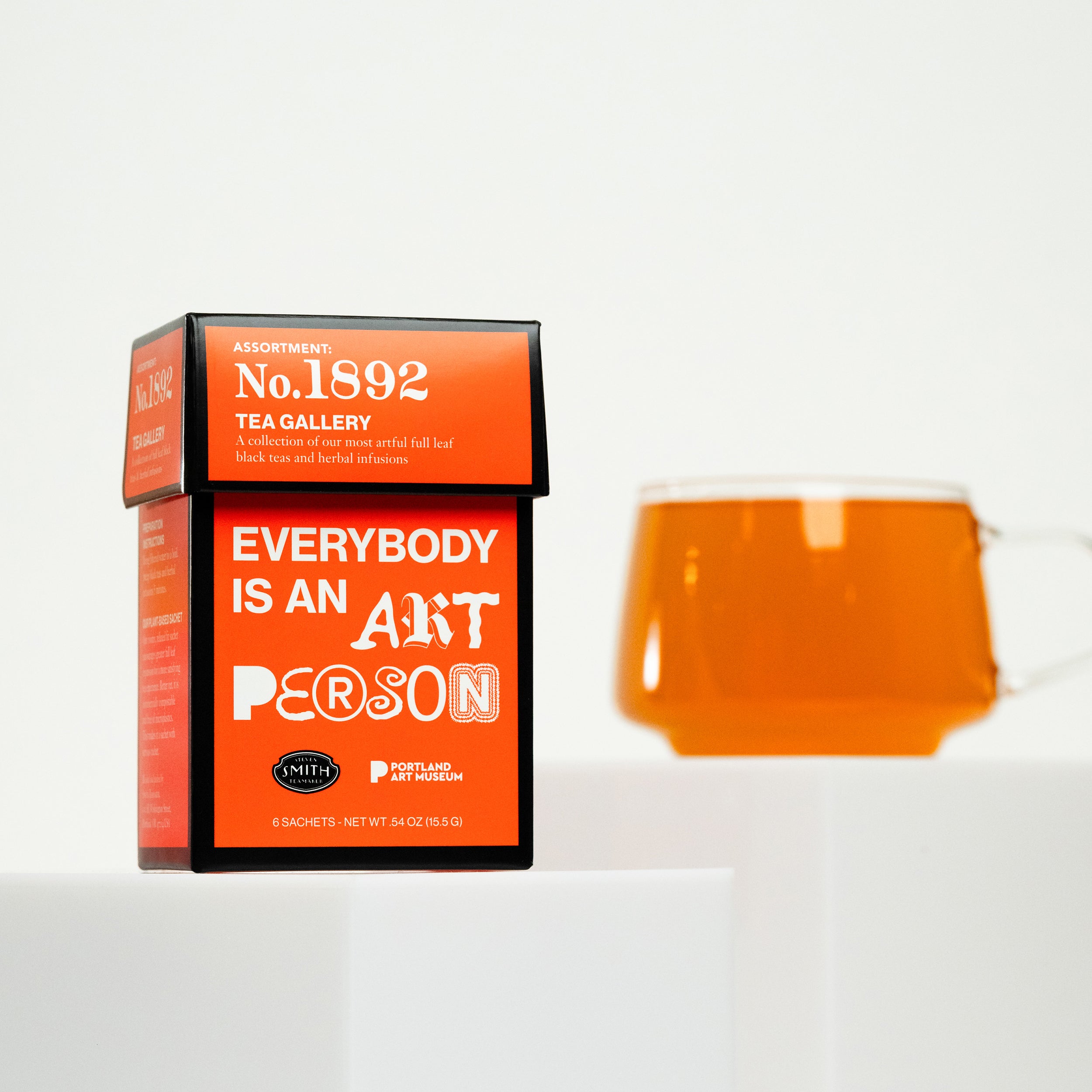 6 count sampler of Tea Gallery with a red carton and the copy "Everybody is an art person" on the front with "art person" written in artistic fonts.