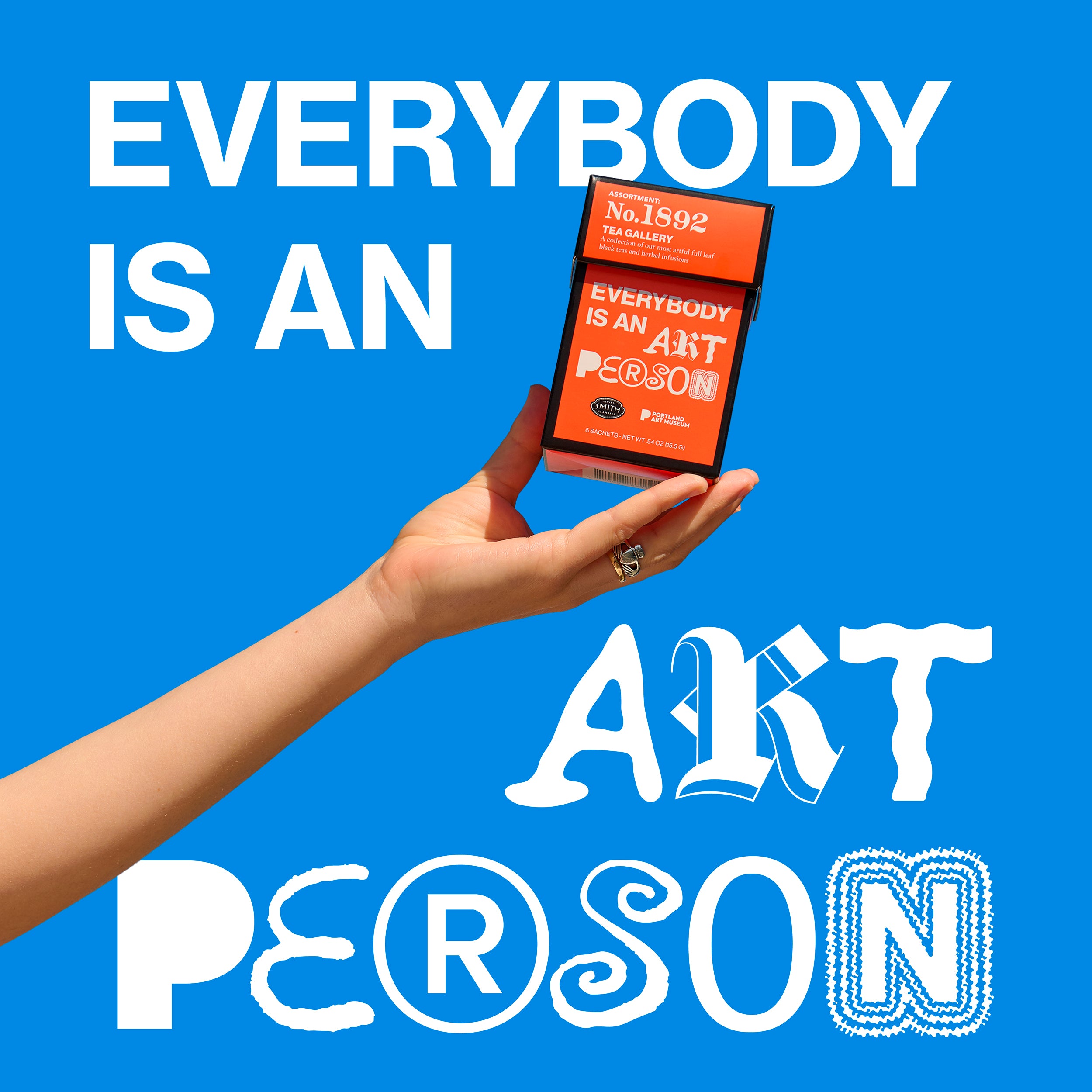 Blue sky background with an arm outstretched holding the Tea Gallery red carton with text overlay "Everybody is an art person".