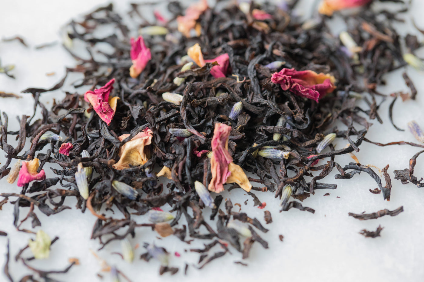 Up close view of loose Black Lavender to show full leaf black tea, rose petals and lavender.