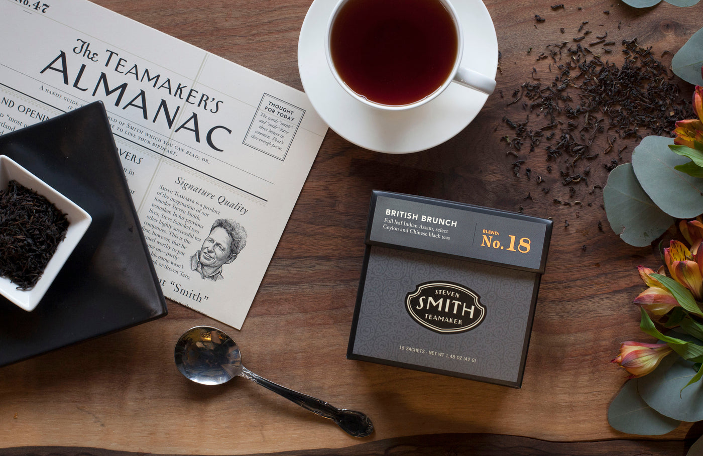 A box of Lord Bergamot on a table with a tasting spoon, a teacup and the Teamaker's almanac.