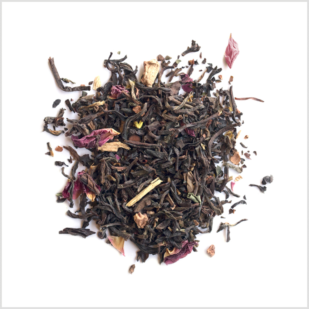 Pile of Broadleaf Blend loose tea to show black tea leaves, rose petals and osmanthus.