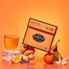 Orange tea package with a glass of tea, ginger root, lemon and other ingredients on an orange background
