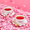 Two Smith branded teacups filled with Lover's Leap black tea on a pile of rose petals.
