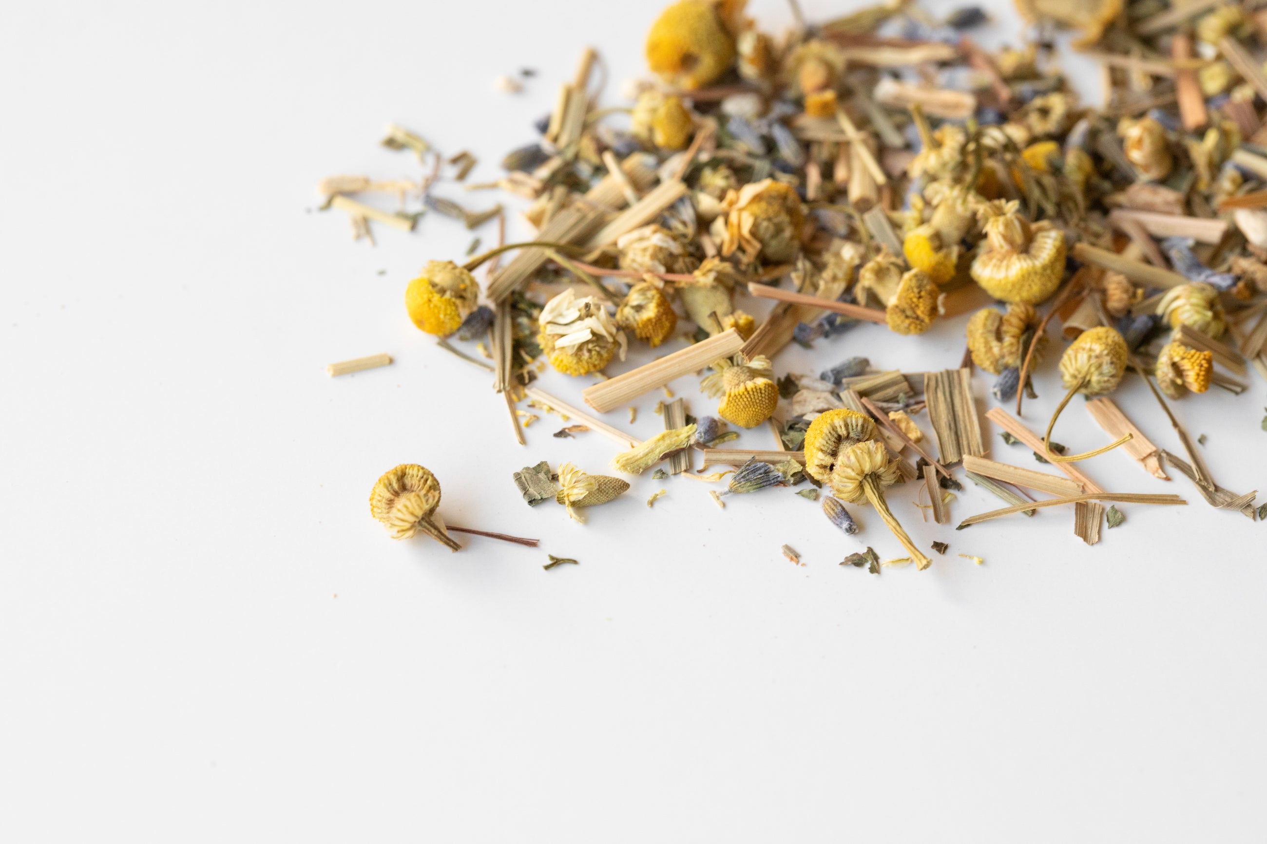 Pile of loose Lullaby blend to show ingredients like lemongrass, chamomile buds and lavender.