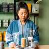 Chef Mei Lin standing behind a wooden table.