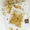Unwrapped sachet of Meadow infusion showing ingredient detail like chamomile buds and petals, blue hysspo and red linden.