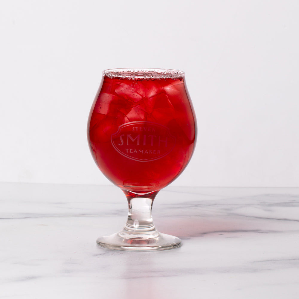 Snifter glass branded with Smith logo on marble background.