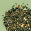 Loose leaf pile of Tokyo Twilight tea to show detail of full leaf green tea, lavender, lemon peel and juniper.