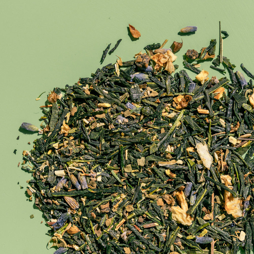 Loose leaf pile of Tokyo Twilight tea to show detail of full leaf green tea, lavender, lemon peel and juniper.