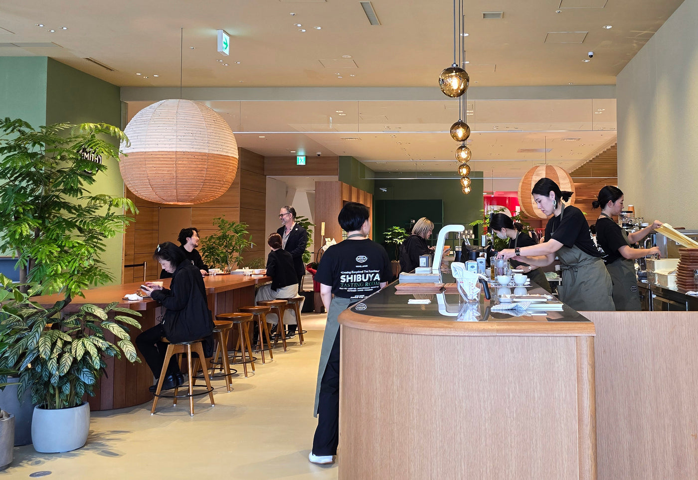 Tokyo Tasting Room and service bar filled with customers and baristas in a busy environment.