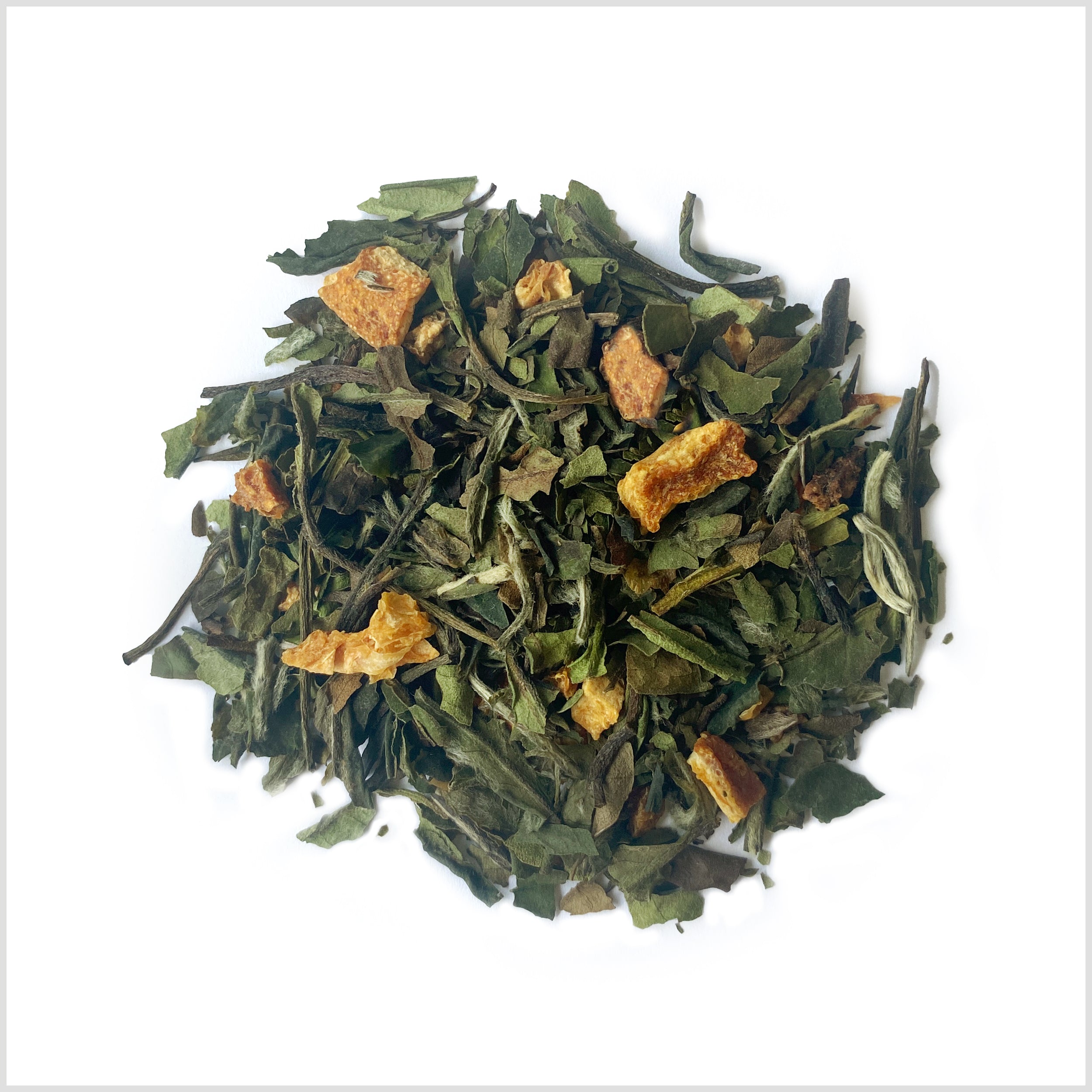 Pile of loose leaf White Peach iced tea to show white tea and orange peel/