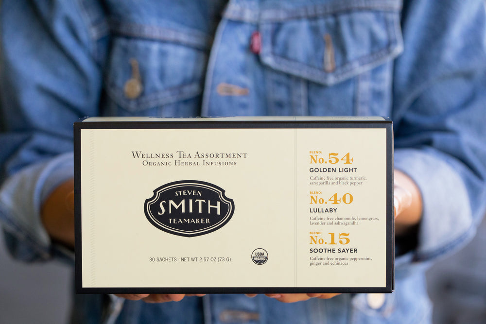 Person holding cream box with black trim.