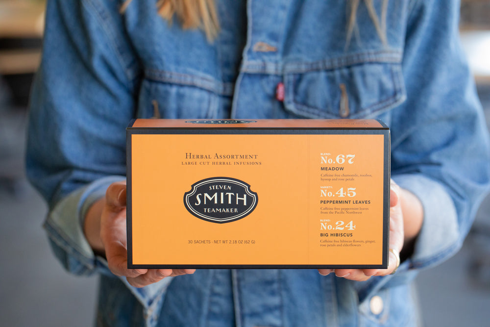 Person holding orange box with black trim.