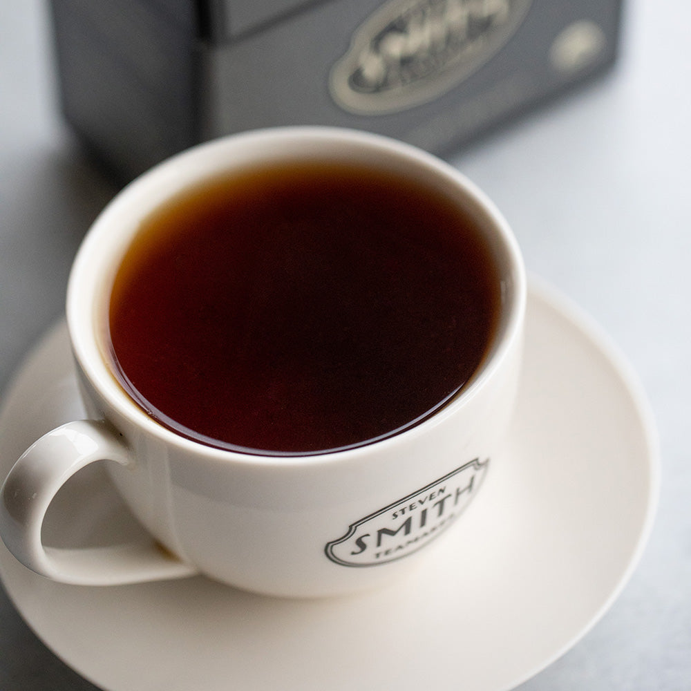 White porcelain cup of dark brown Masala Chai tea. 