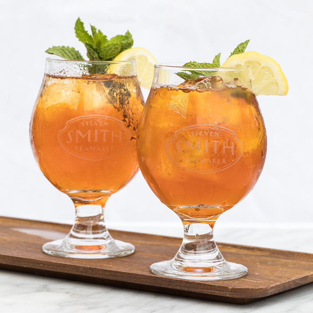 Two snifter glasses branded with Smith logo on marble background.