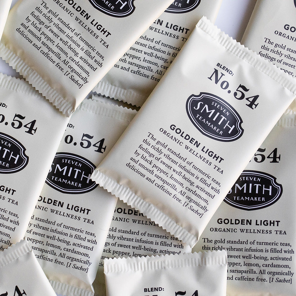 A pile of overwrapped sachets of Golden Light wellness tea.