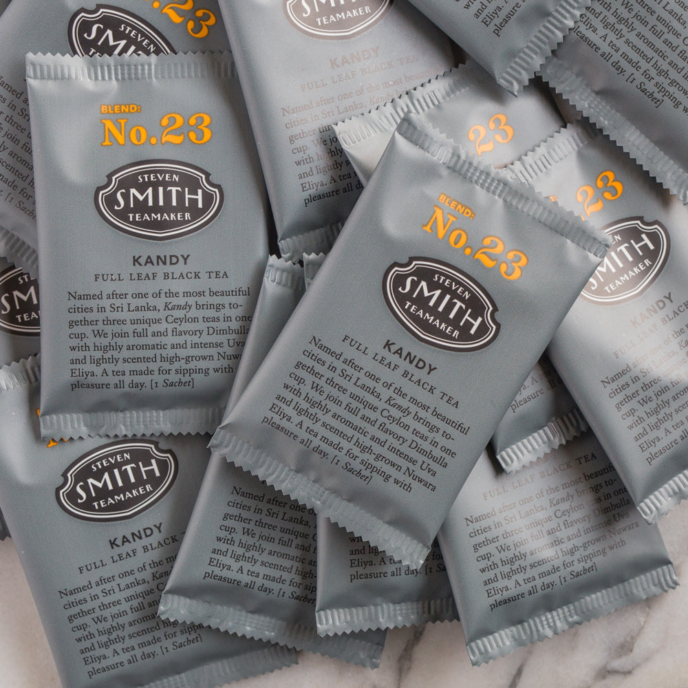 A pile of overwrapped sachets of Kandy black tea.