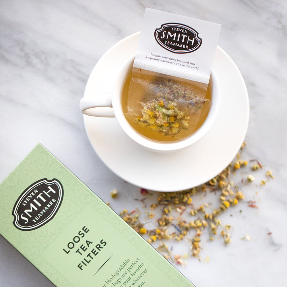 White paper filter with black Smith logo shield filled with chamomile petals.