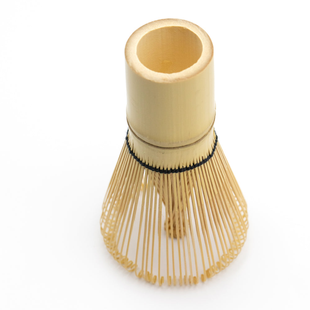 Bamboo matcha whisk with black thread.