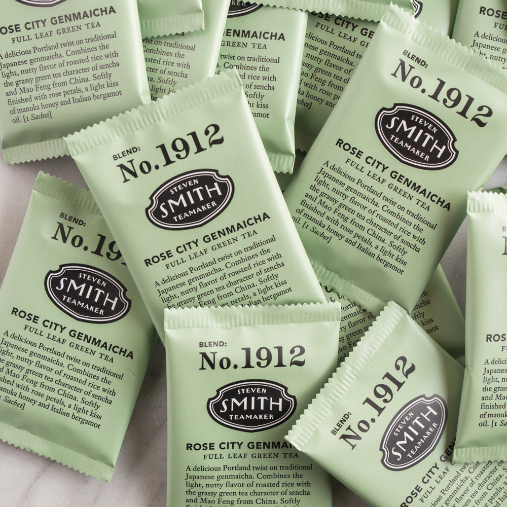 A pile of overwrapped sachets of Rose City Genmaicha green tea.