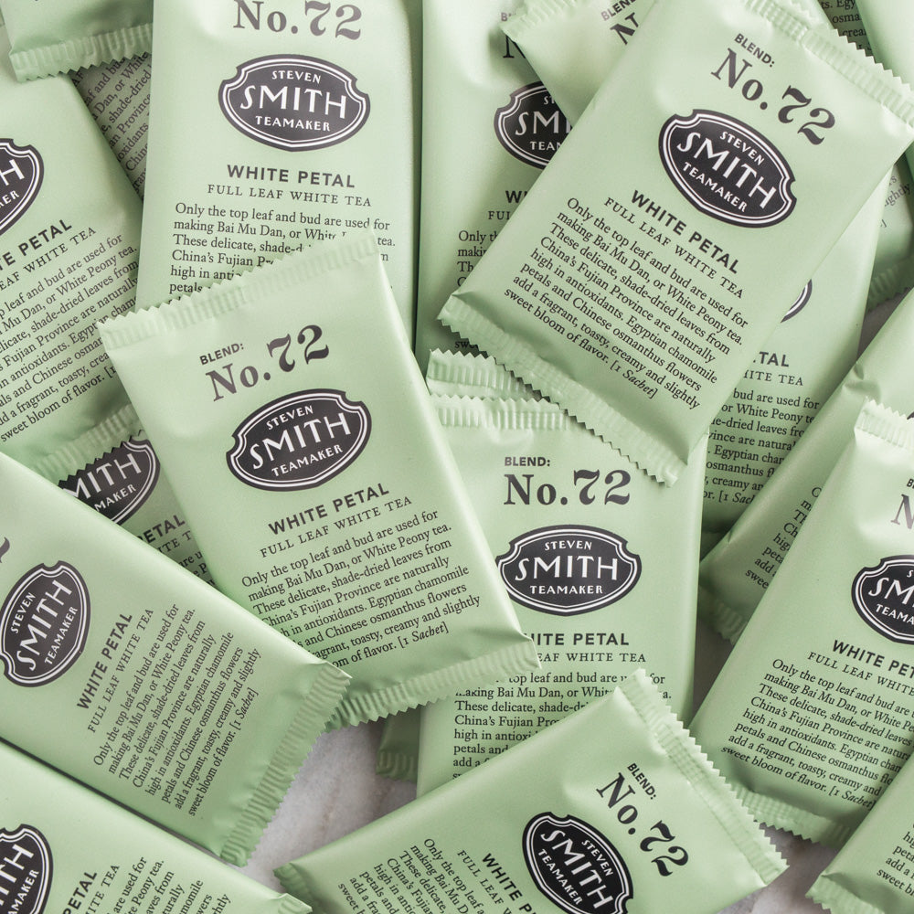 A pile of overwrapped sachets of White Petal white tea.