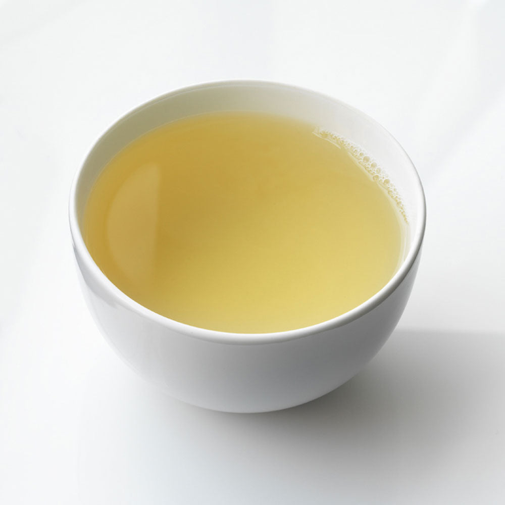 Cup of white petal in porcelain cup on white background.